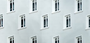 a white building with many windows and a clock