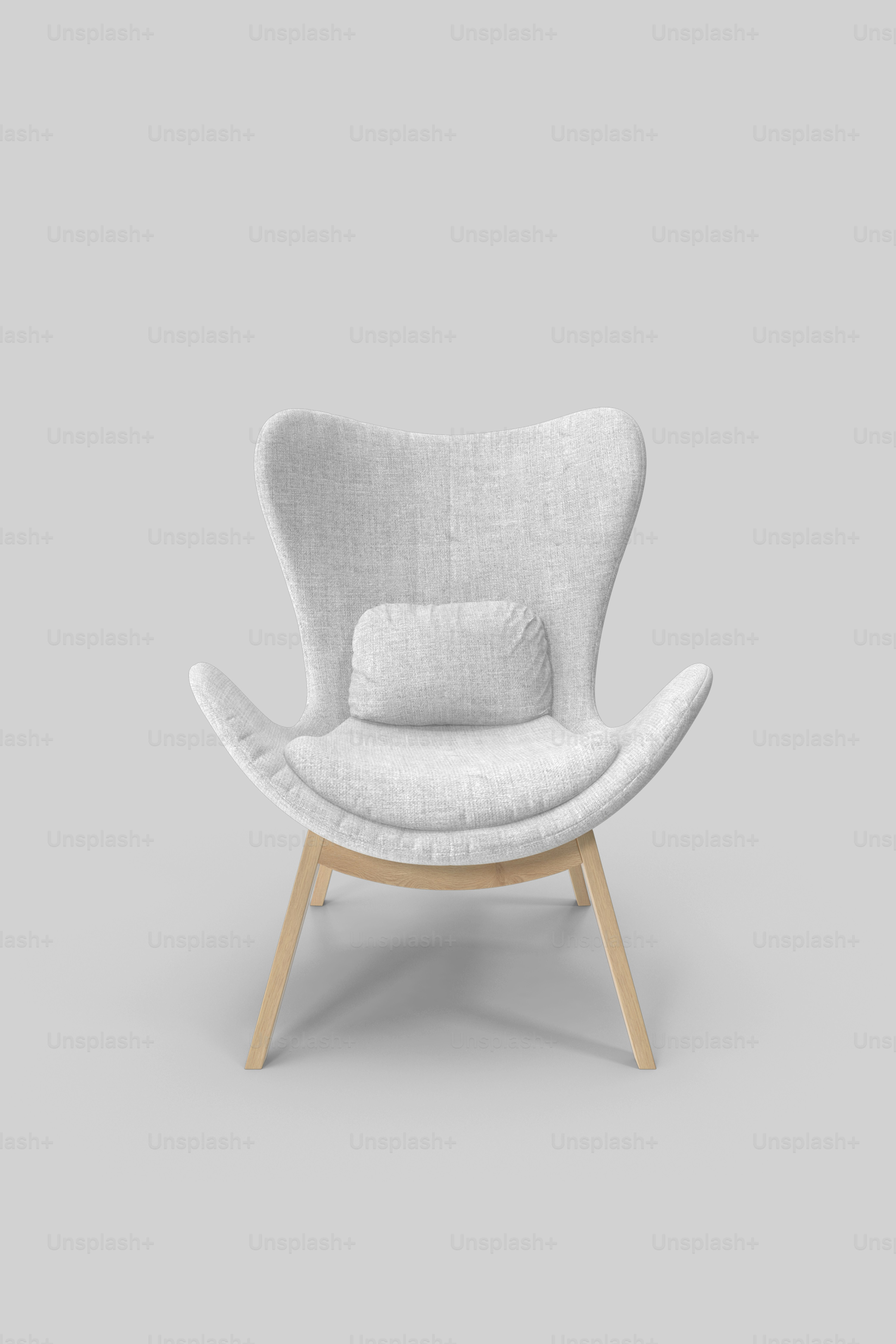 a white chair with a pillow on top of it