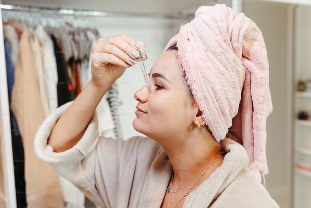 a woman with a pink towel on her head