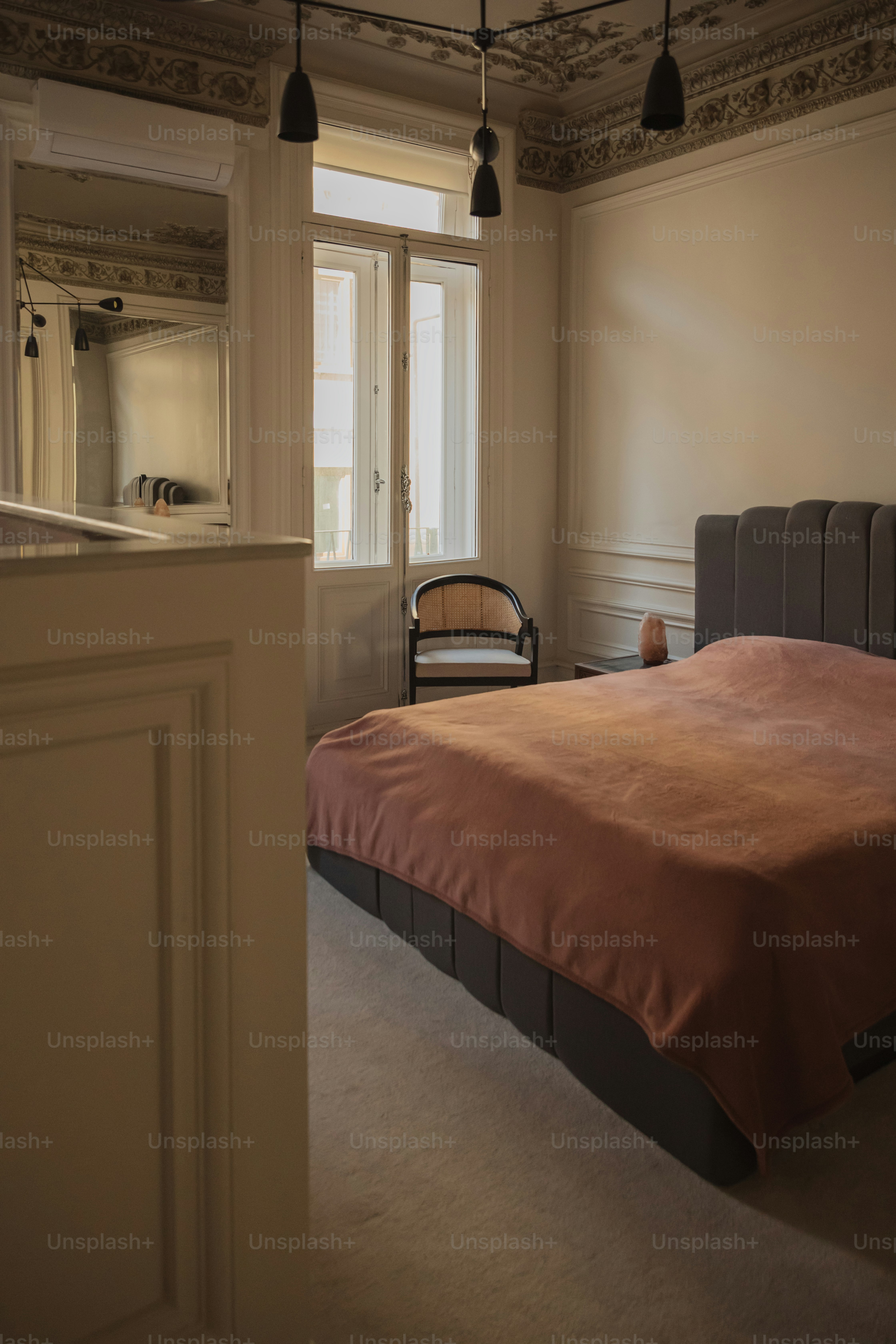 a bed sitting in a bedroom next to a window