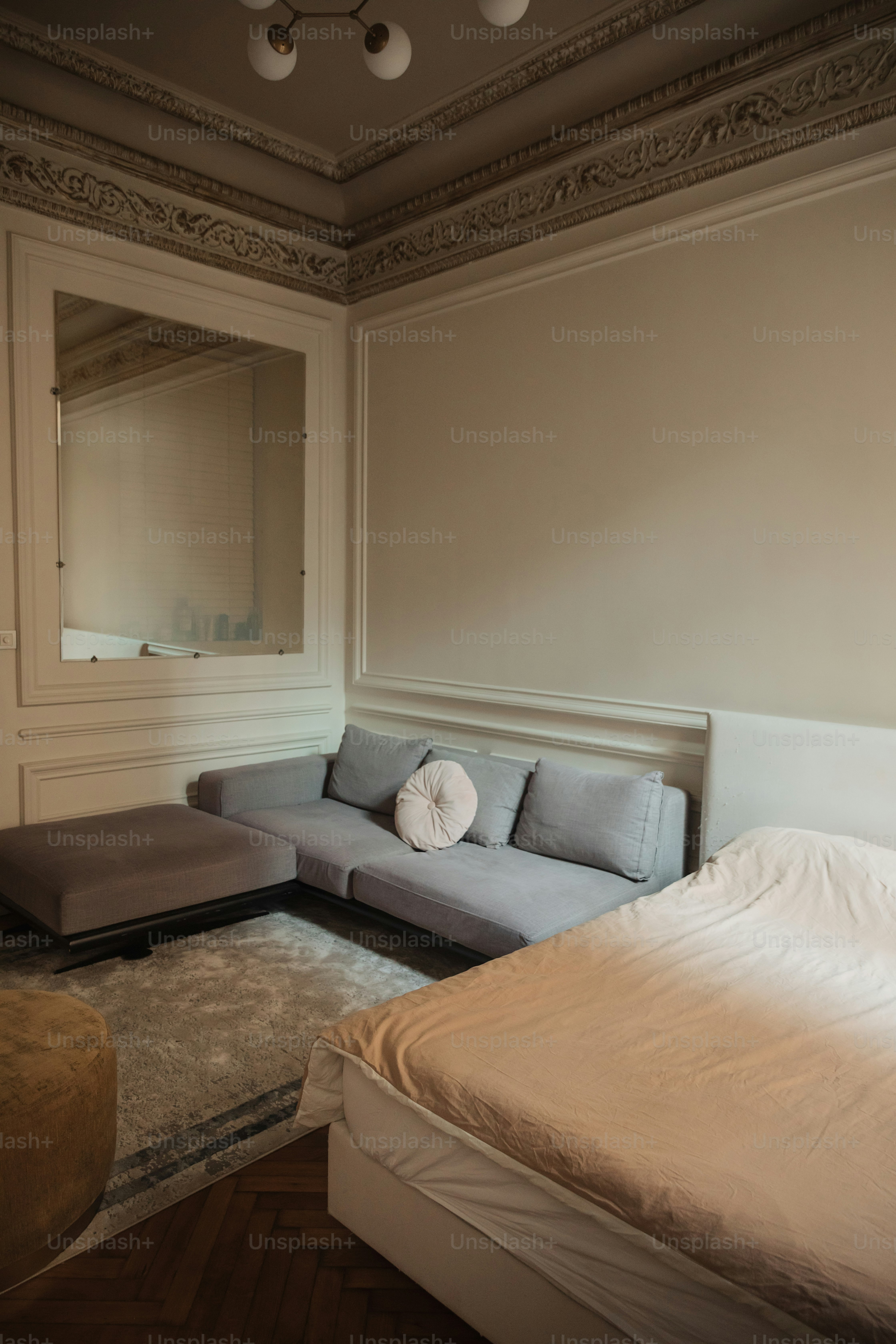 a bed sitting next to a couch in a bedroom