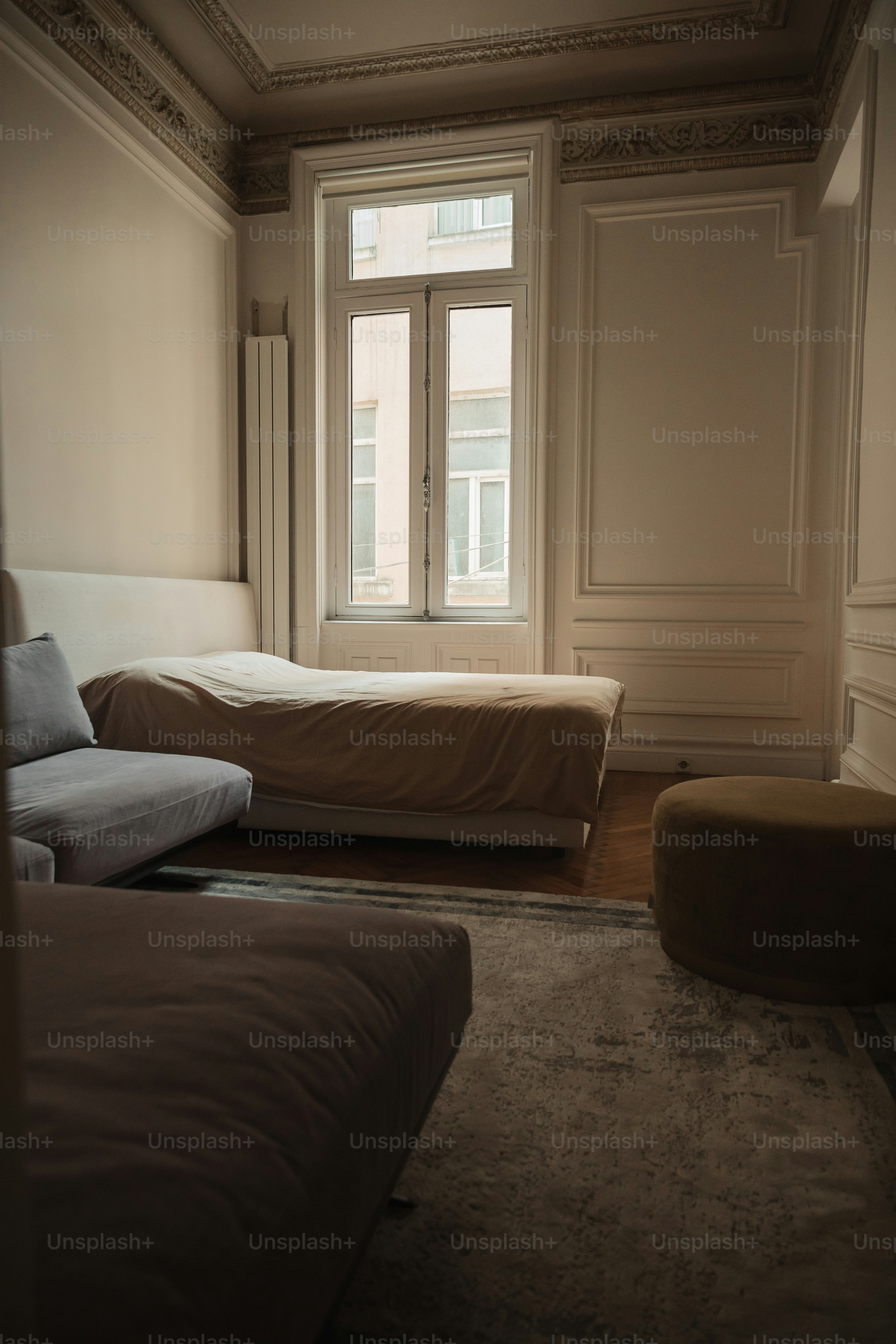 a bedroom with two beds and a large window