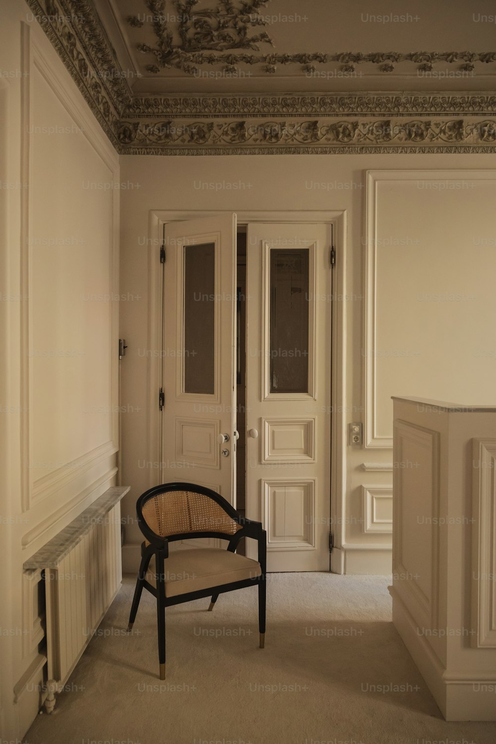 a chair sitting in a room next to two doors