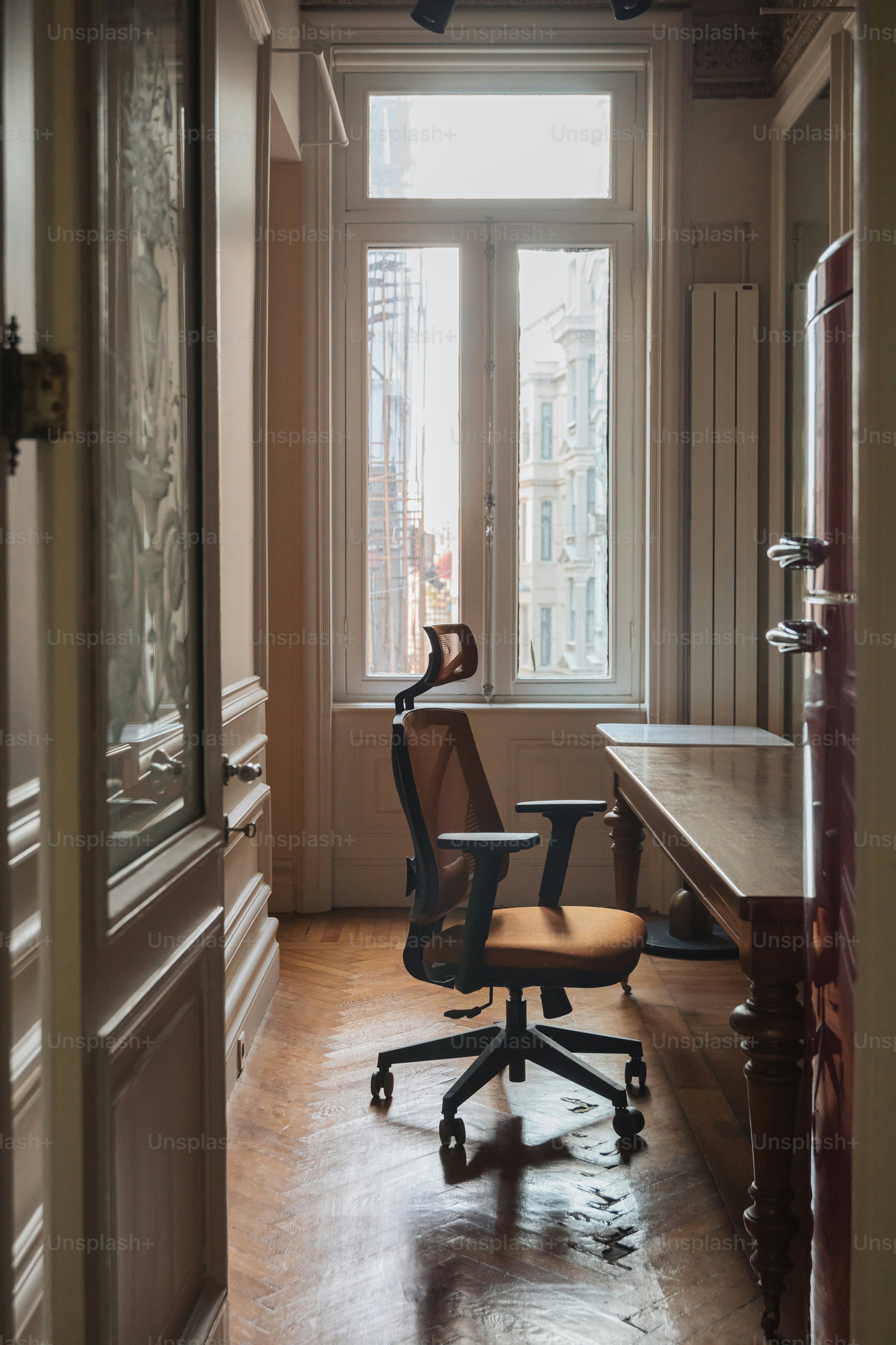 a chair sitting in a room next to a window