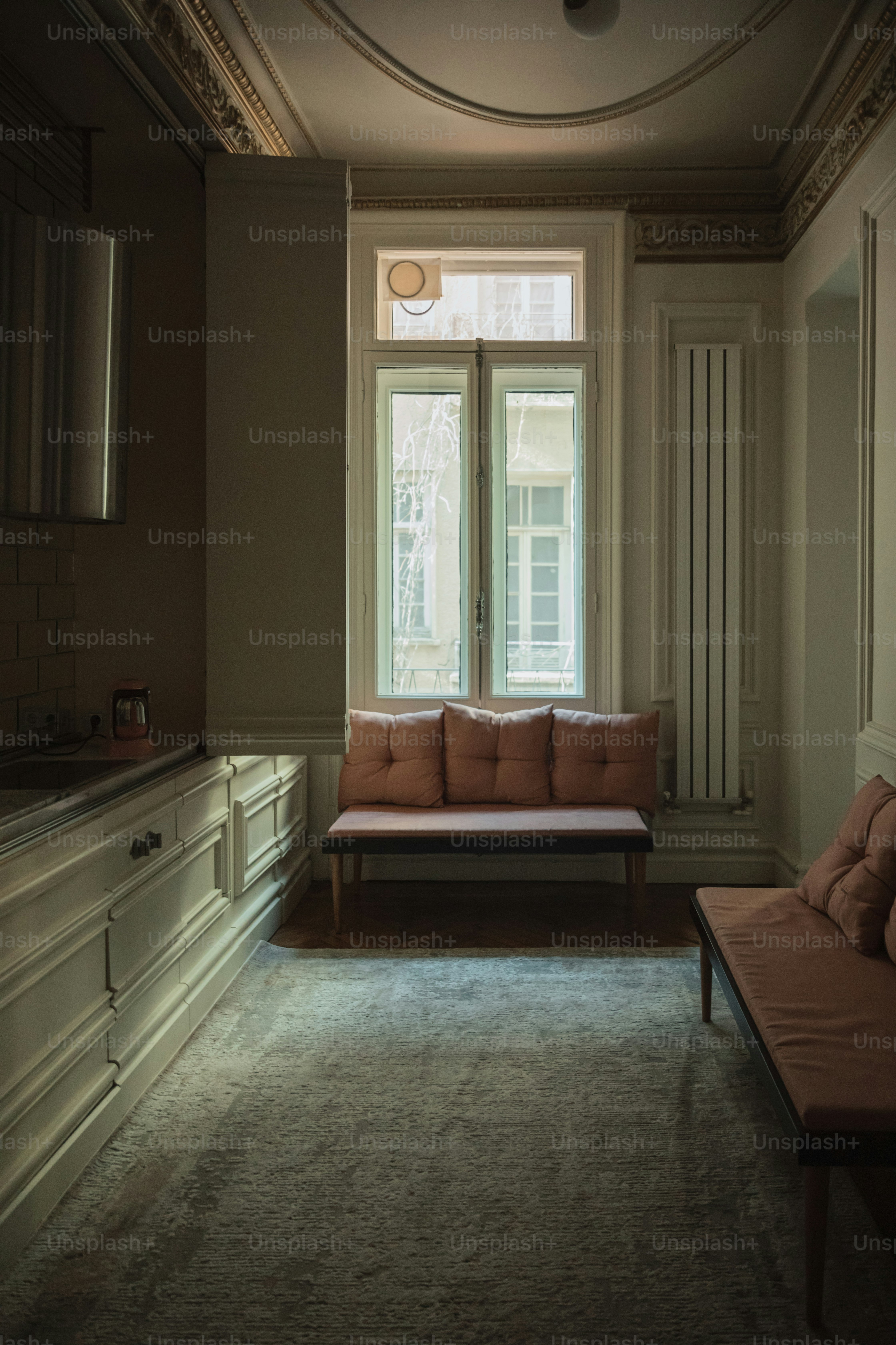 uma sala de estar com um sofá e uma janela