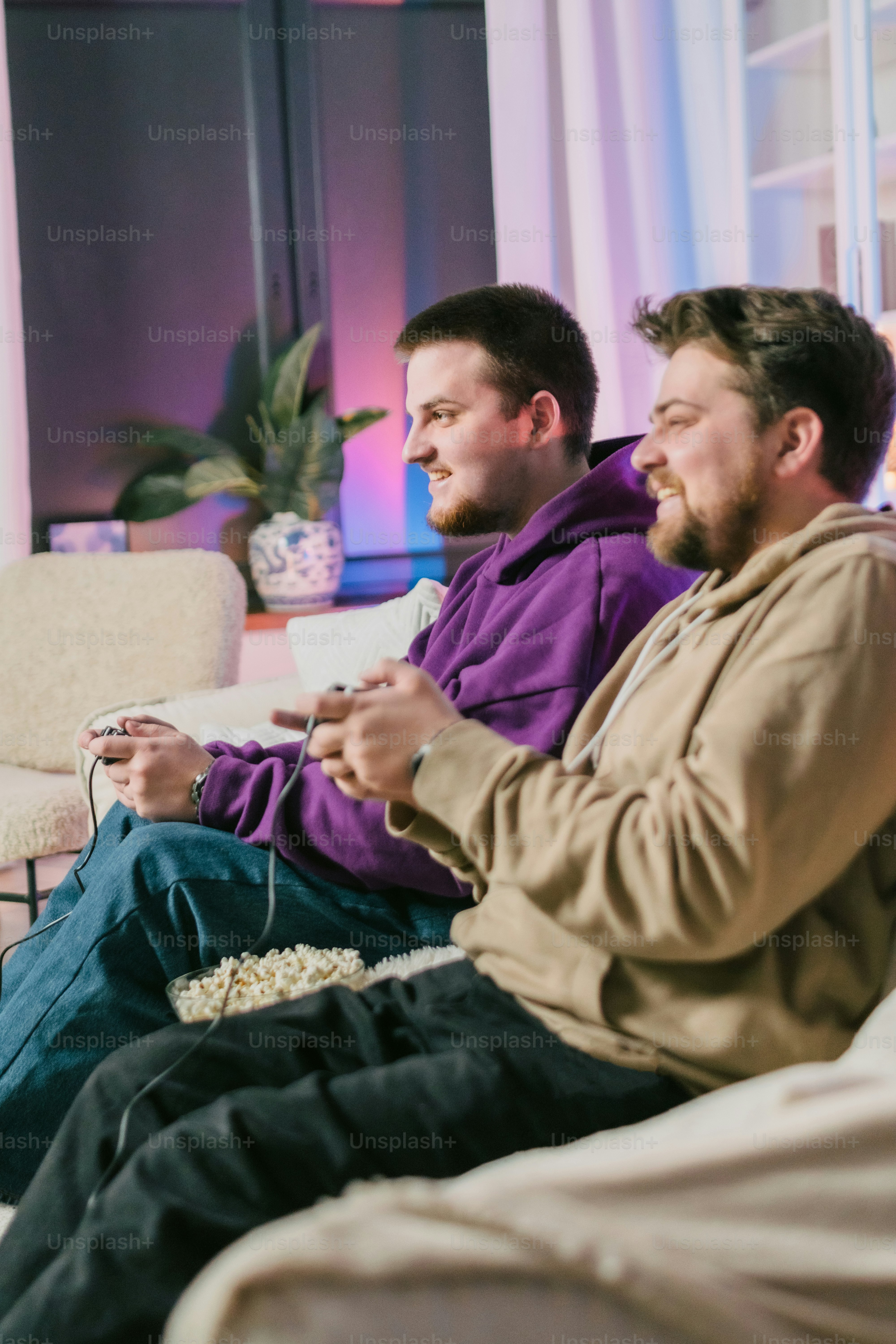 a couple of men sitting on top of a couch