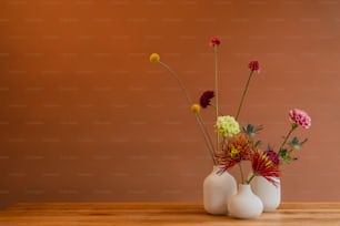 a couple of vases with flowers in them on a table