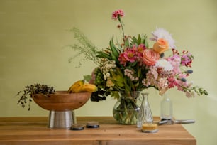 a wooden table topped with a vase filled with flowers
