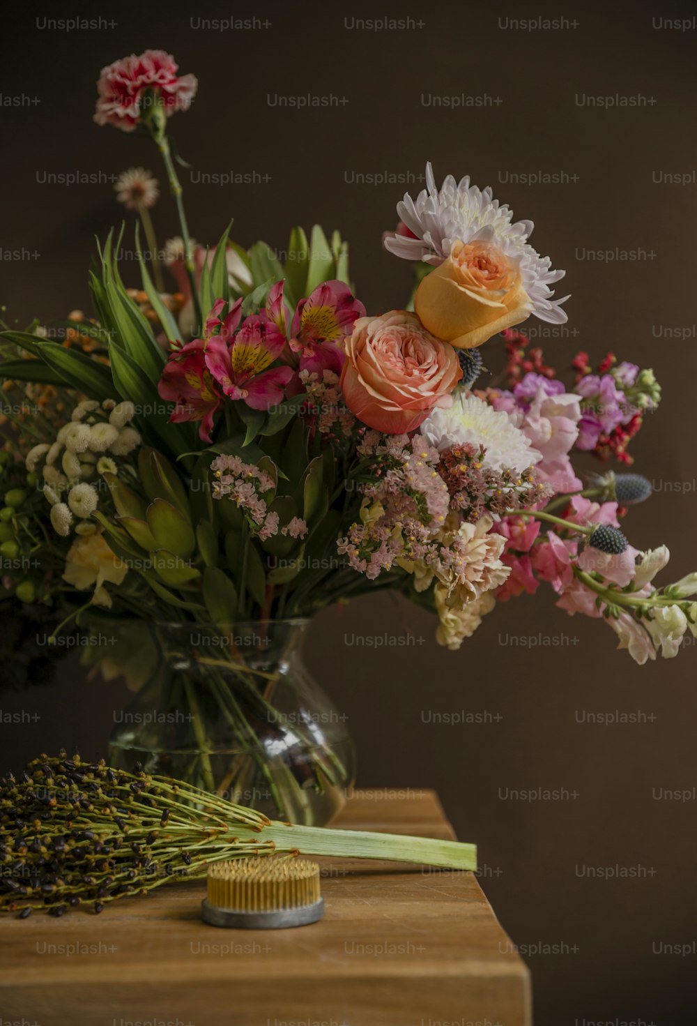 a vase filled with lots of flowers on top of a table