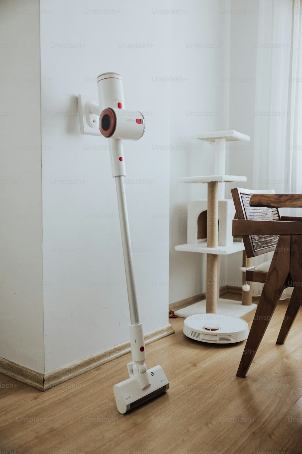 a room with a wooden floor and a white floor lamp