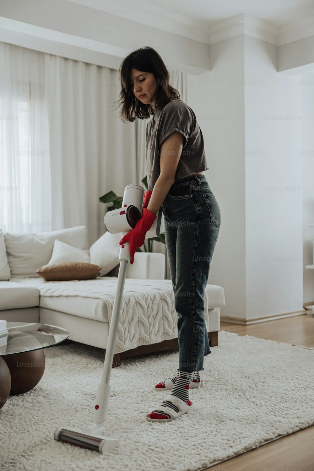 a woman using a vacuum cleaner on a rug