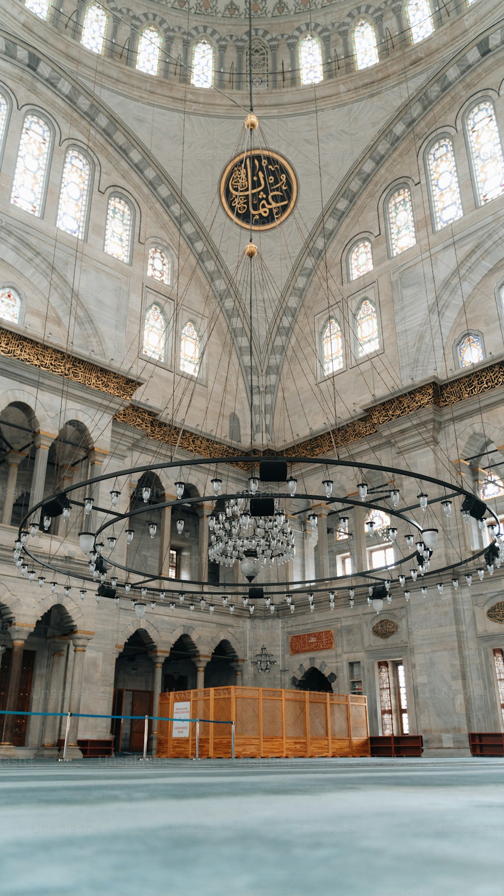 the inside of a building with a clock hanging from the ceiling