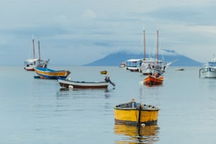 a group of boats floating on top of a large body of water