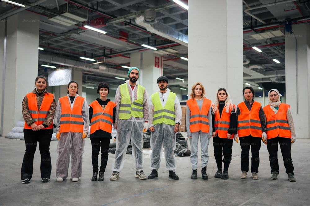 a group of people in safety vests posing for a picture