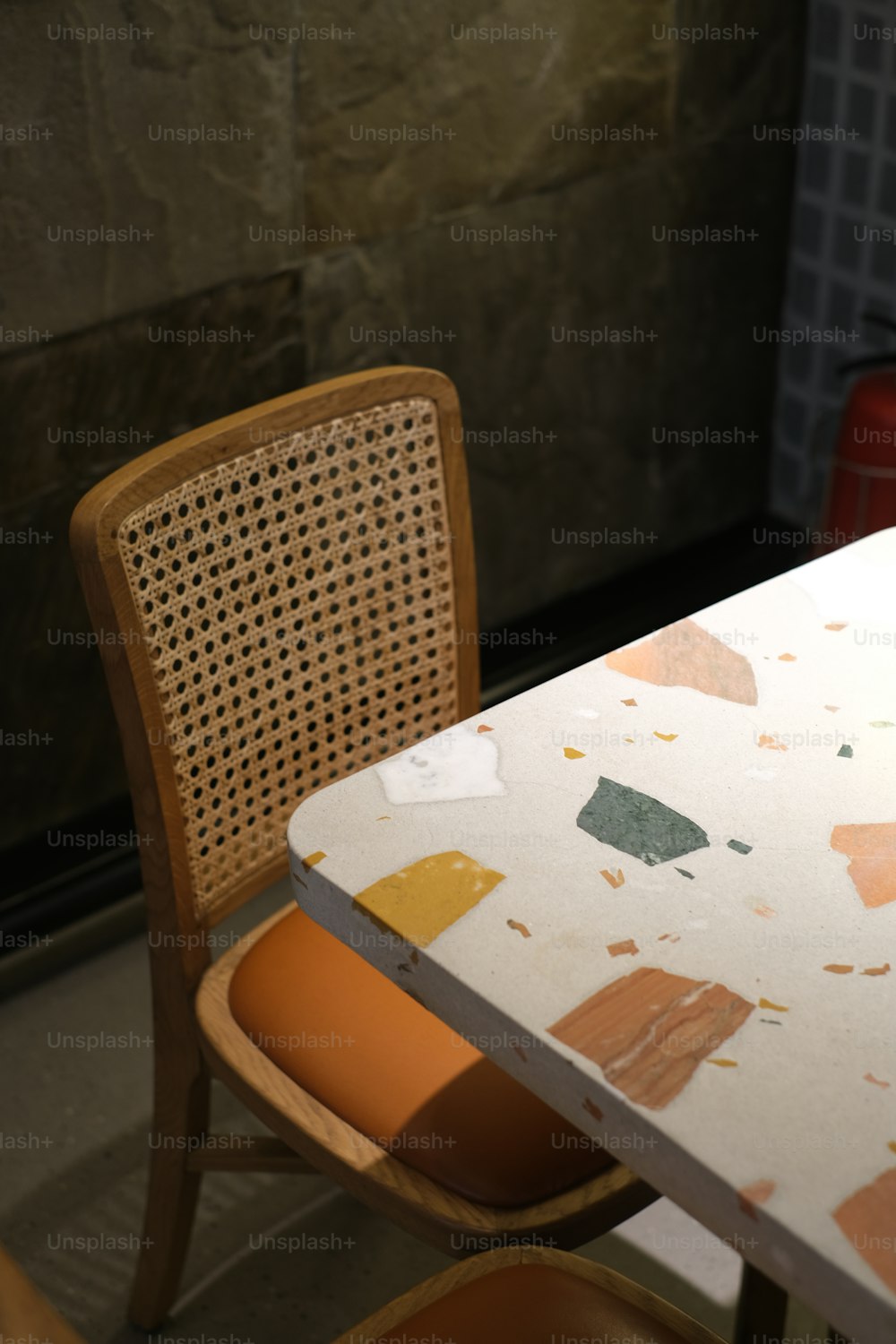 a white table with a wooden chair next to it