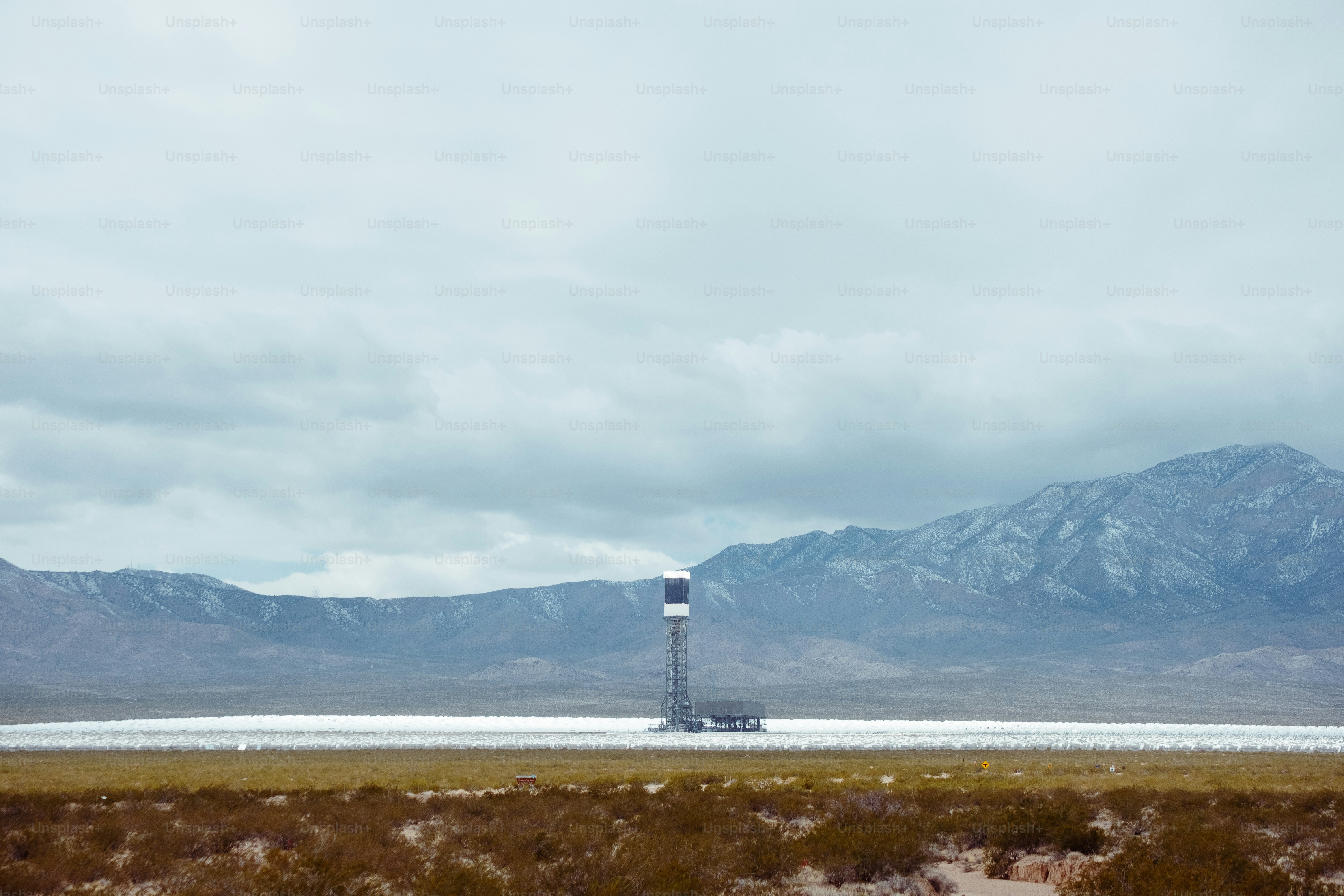 a large body of water with mountains in the background