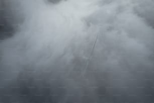 a plane flying through a cloud filled sky