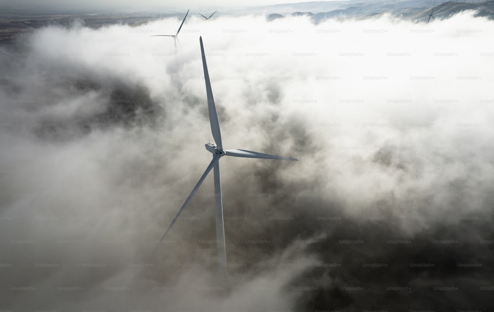 a wind turbine in the middle of a foggy field