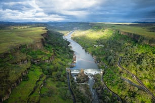 a river running through a lush green valley