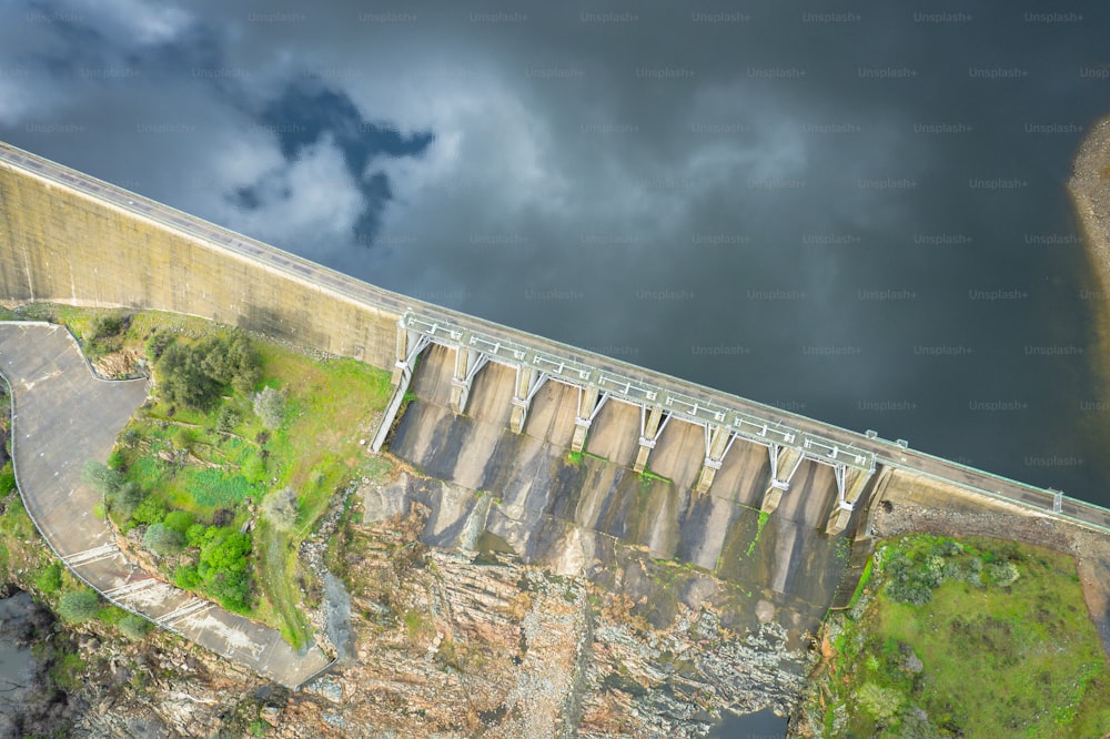 an aerial view of a dam and a road