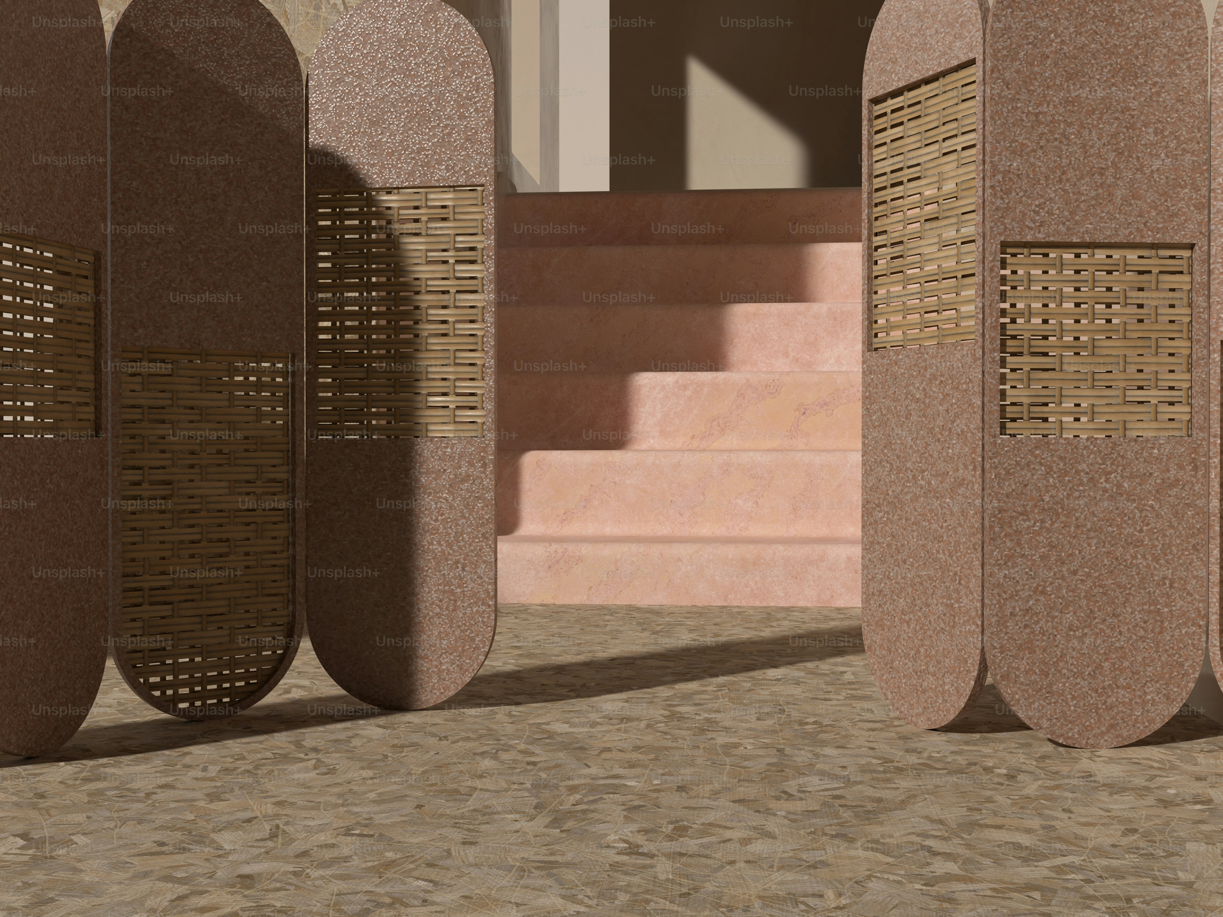 砂地の上に座っている3つの石の彫刻のセット