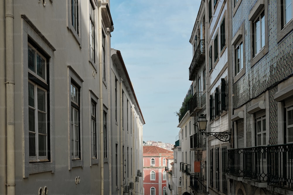 a narrow city street with buildings and balconies