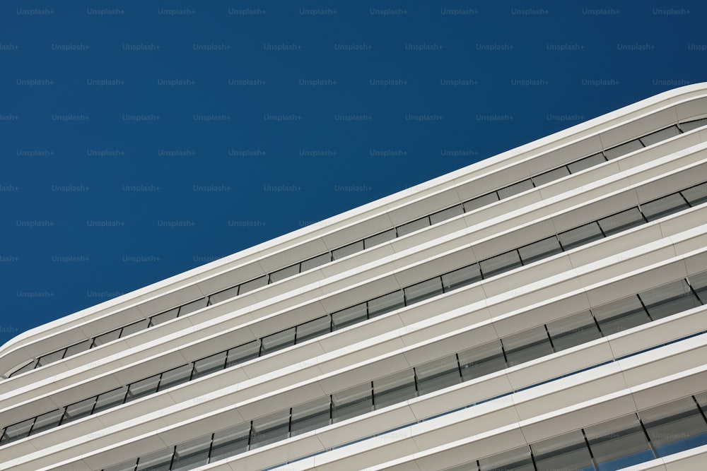 an airplane flying in the sky over a building