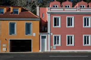 a row of colorful houses with a car parked in front of them