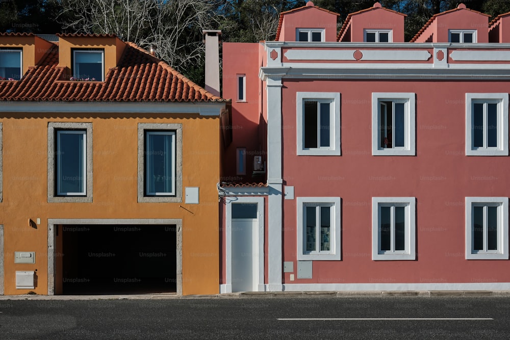 a row of colorful houses with a car parked in front of them