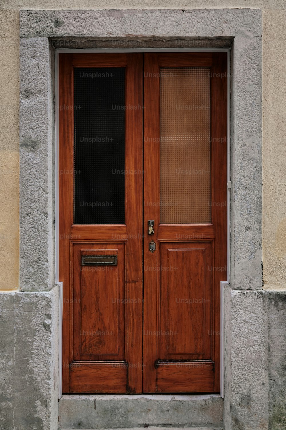 a wooden door with a window on a building