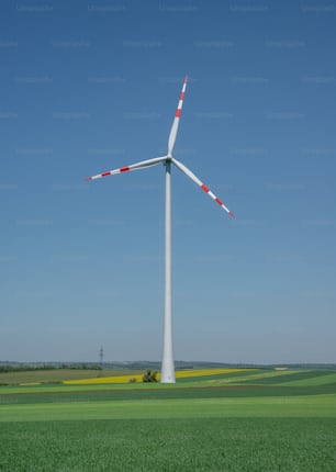 a wind turbine in the middle of a green field
