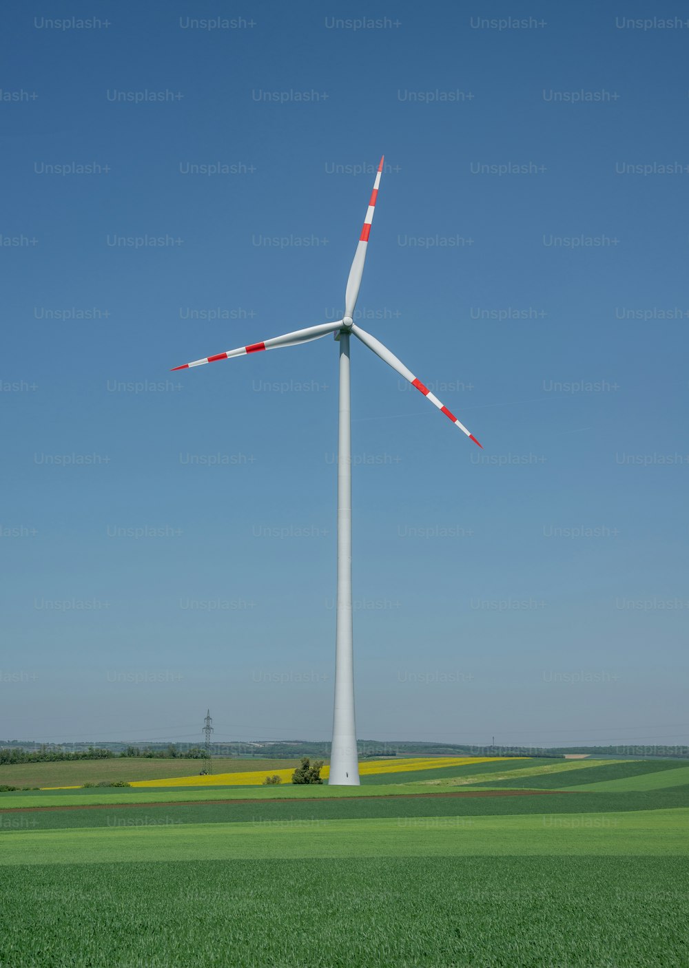 a wind turbine in the middle of a green field