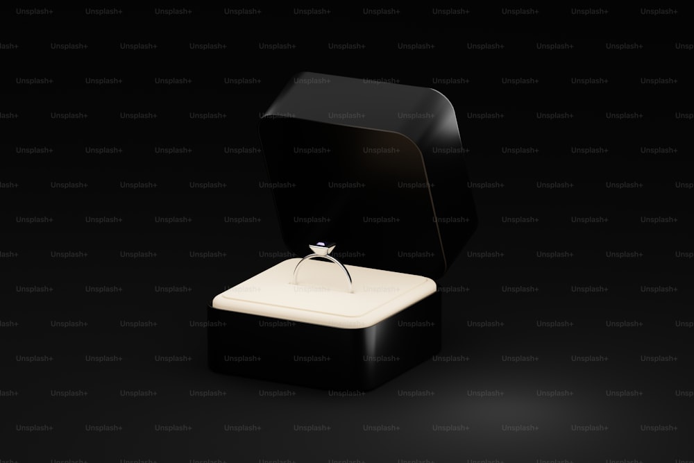 a diamond ring in a black box on a black background