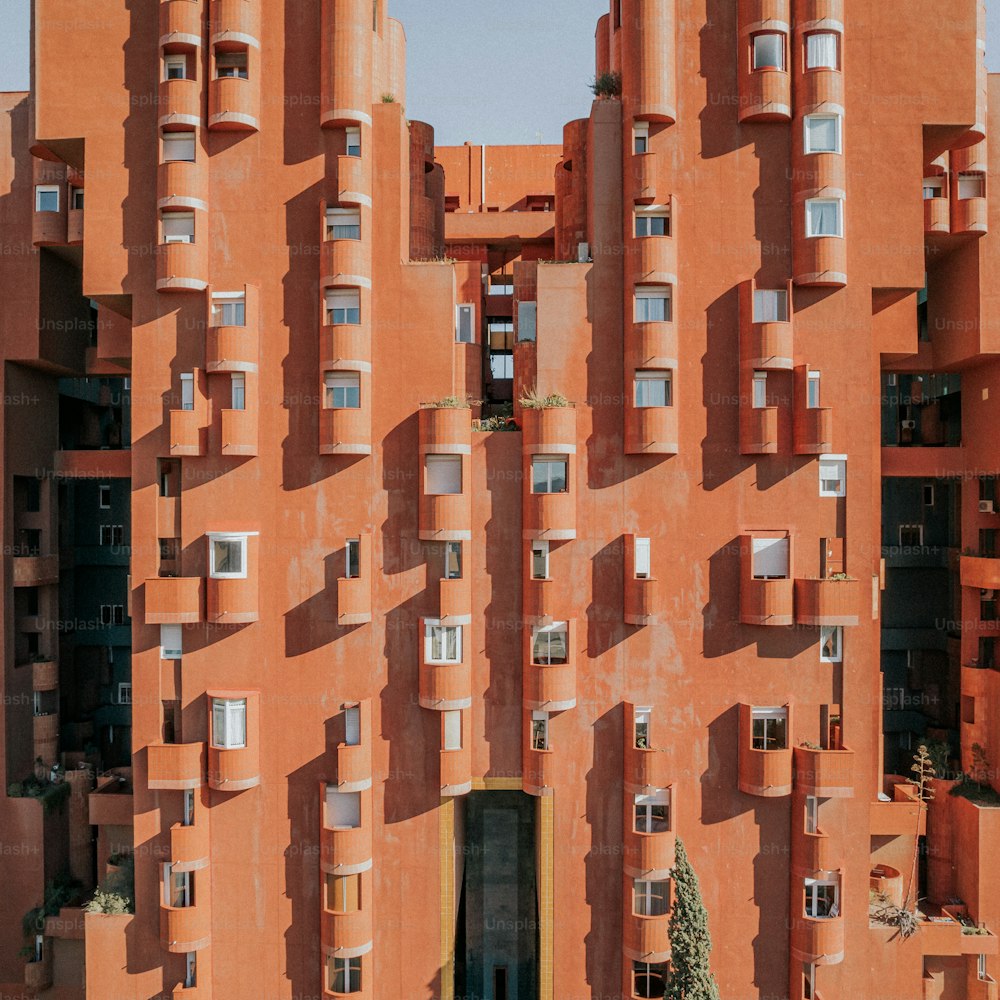 a tall orange building with lots of windows