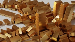 Una pila de cajas de oro sentadas encima de una mesa blanca