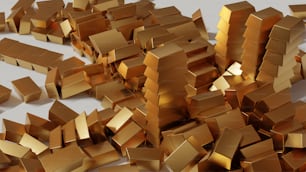 a pile of gold boxes sitting on top of a white table