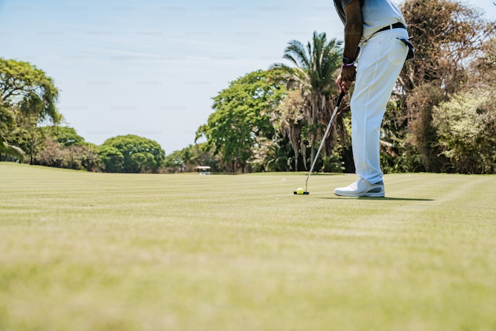 a man playing golf on a sunny day