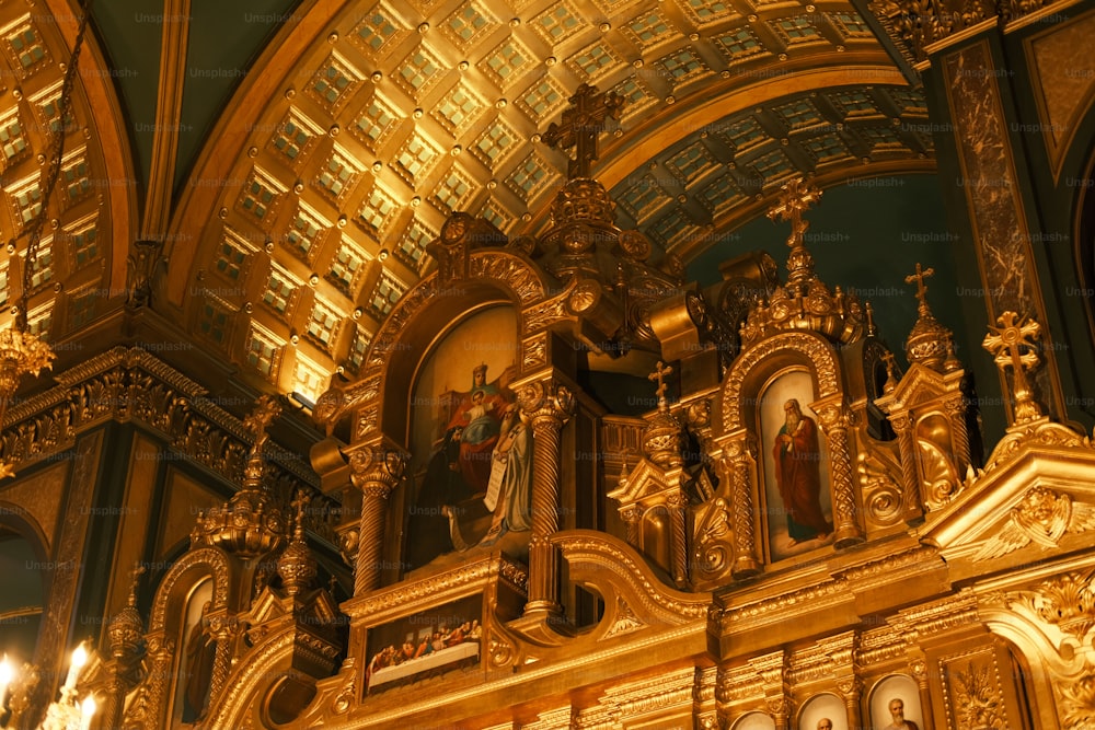 a golden alter in a church with chandeliers