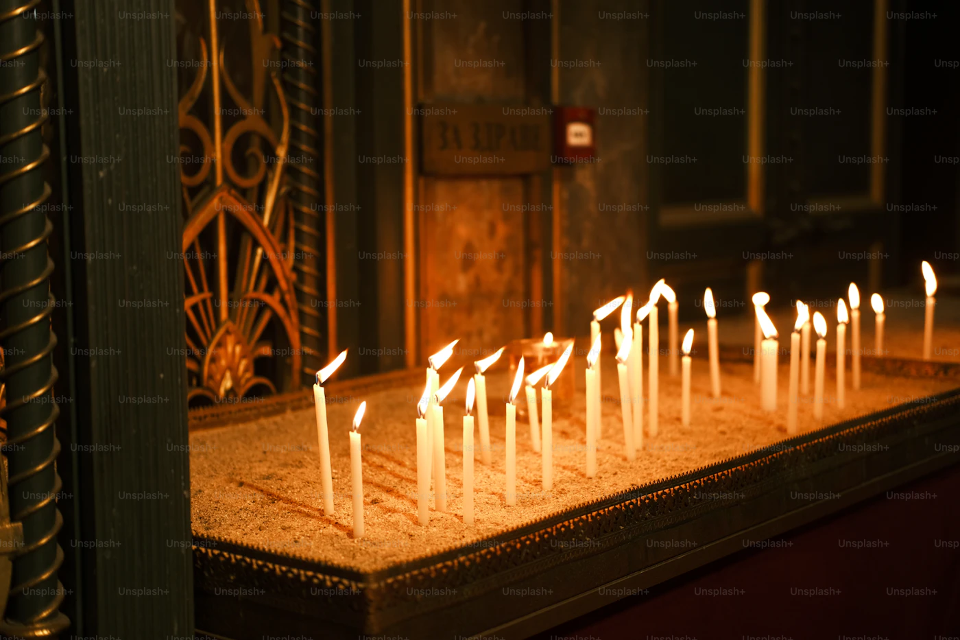 Votive candles burning in a dark chapel