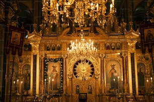 a golden alter with a chandelier in a church