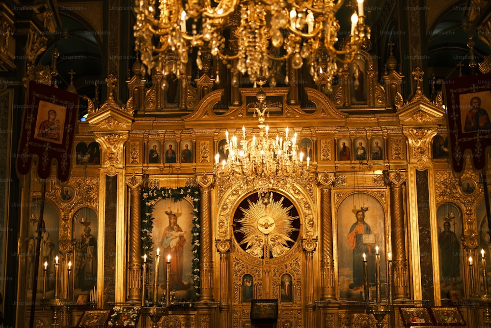 a golden alter with a chandelier in a church