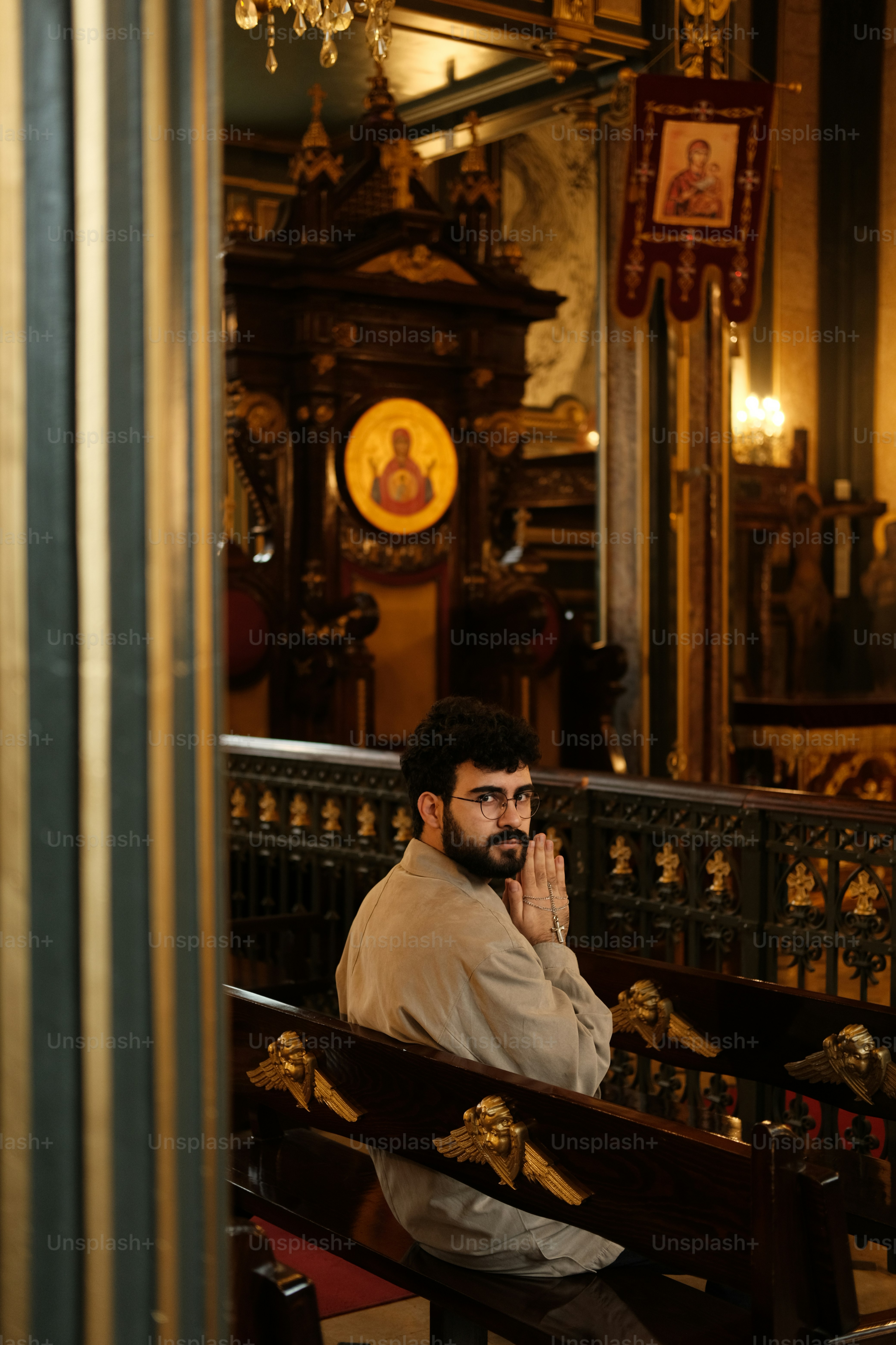 a man sitting on a bench in a church