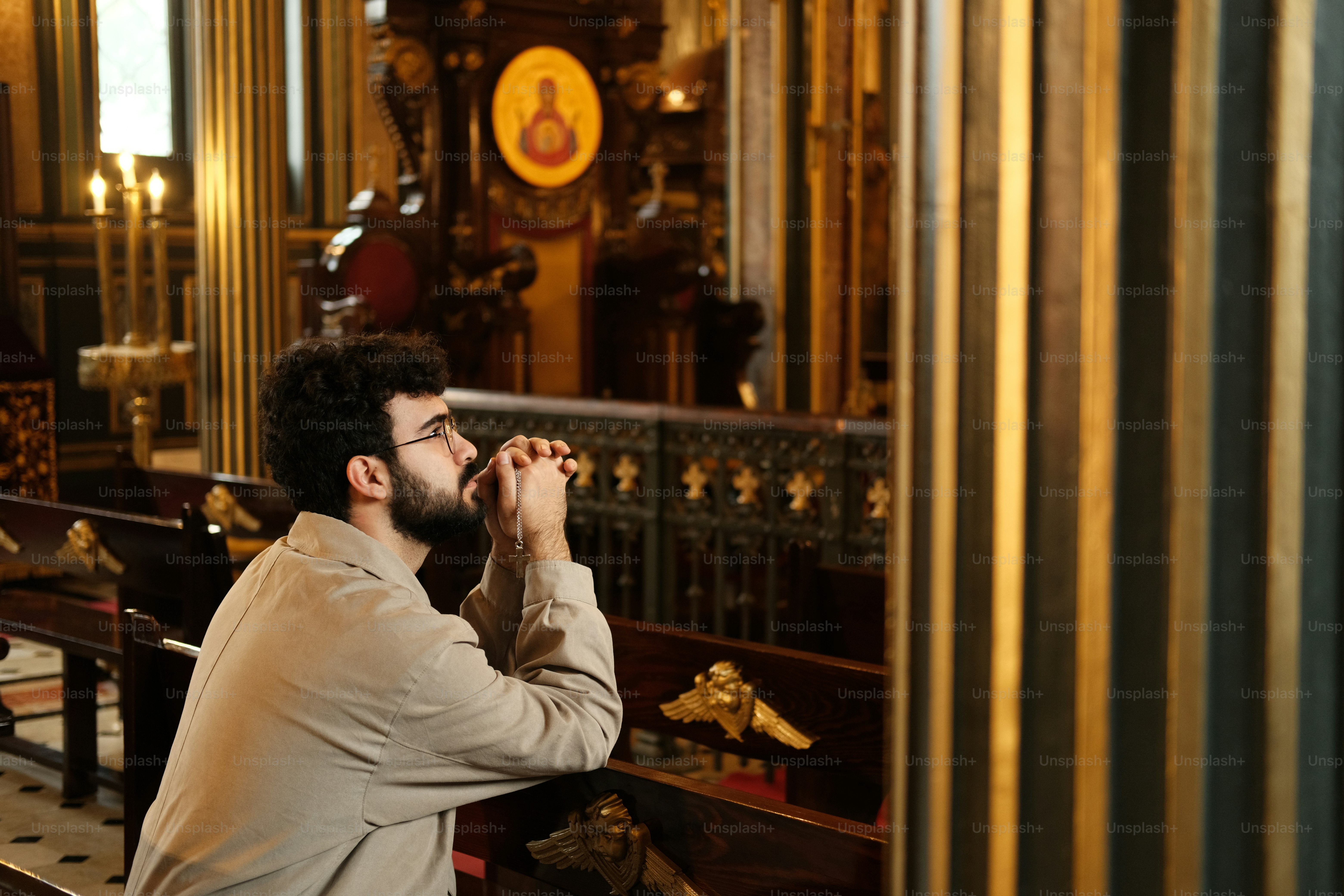 a man sitting on a bench in a church
