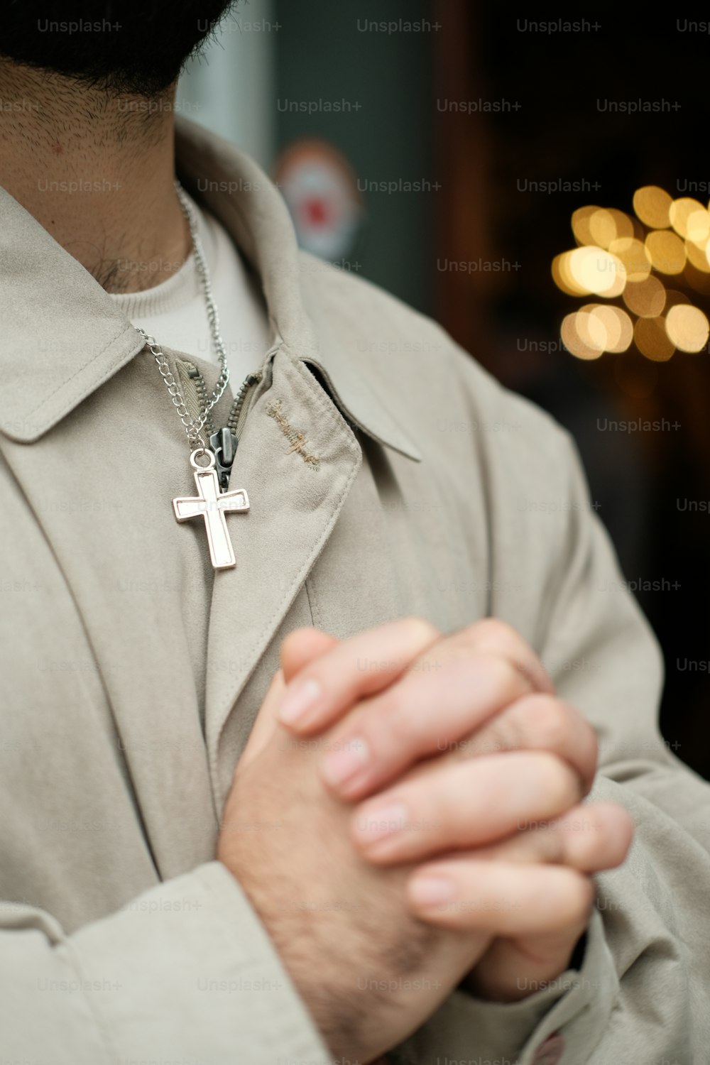 a close up of a person wearing a cross necklace