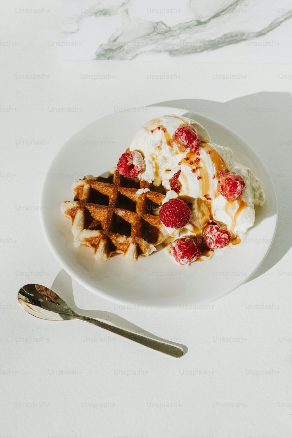 a white plate topped with waffles and ice cream