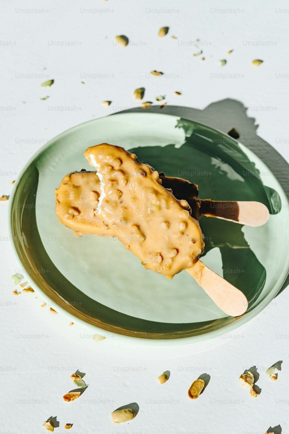 a green plate topped with a waffle covered in peanut butter