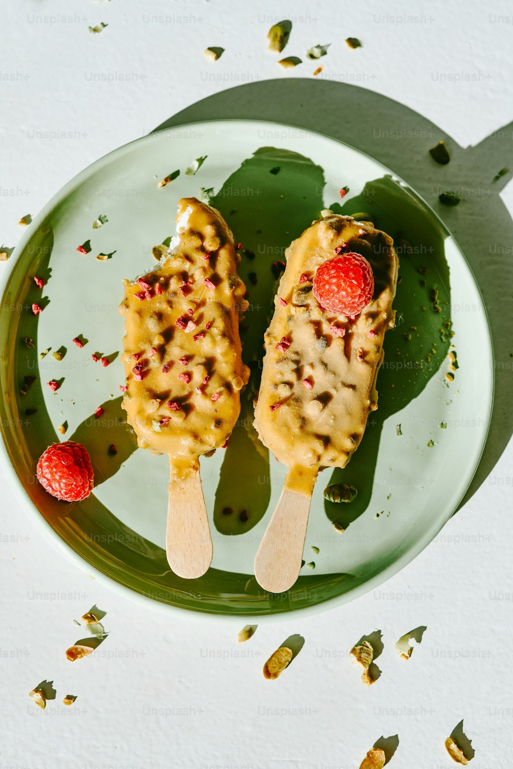 a couple of popsicles sitting on top of a green plate