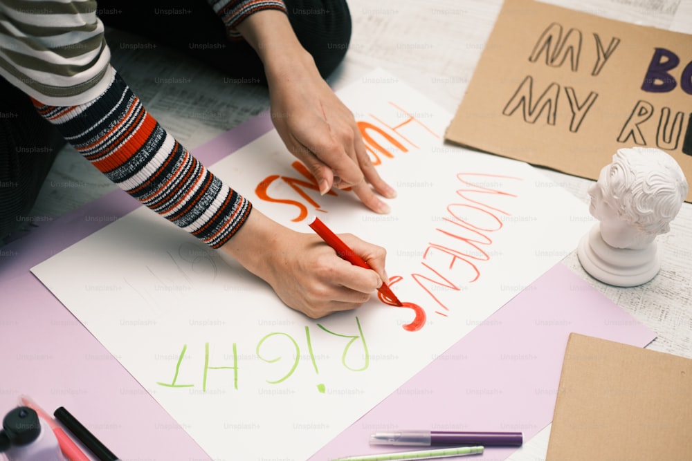 a person is writing on a piece of paper