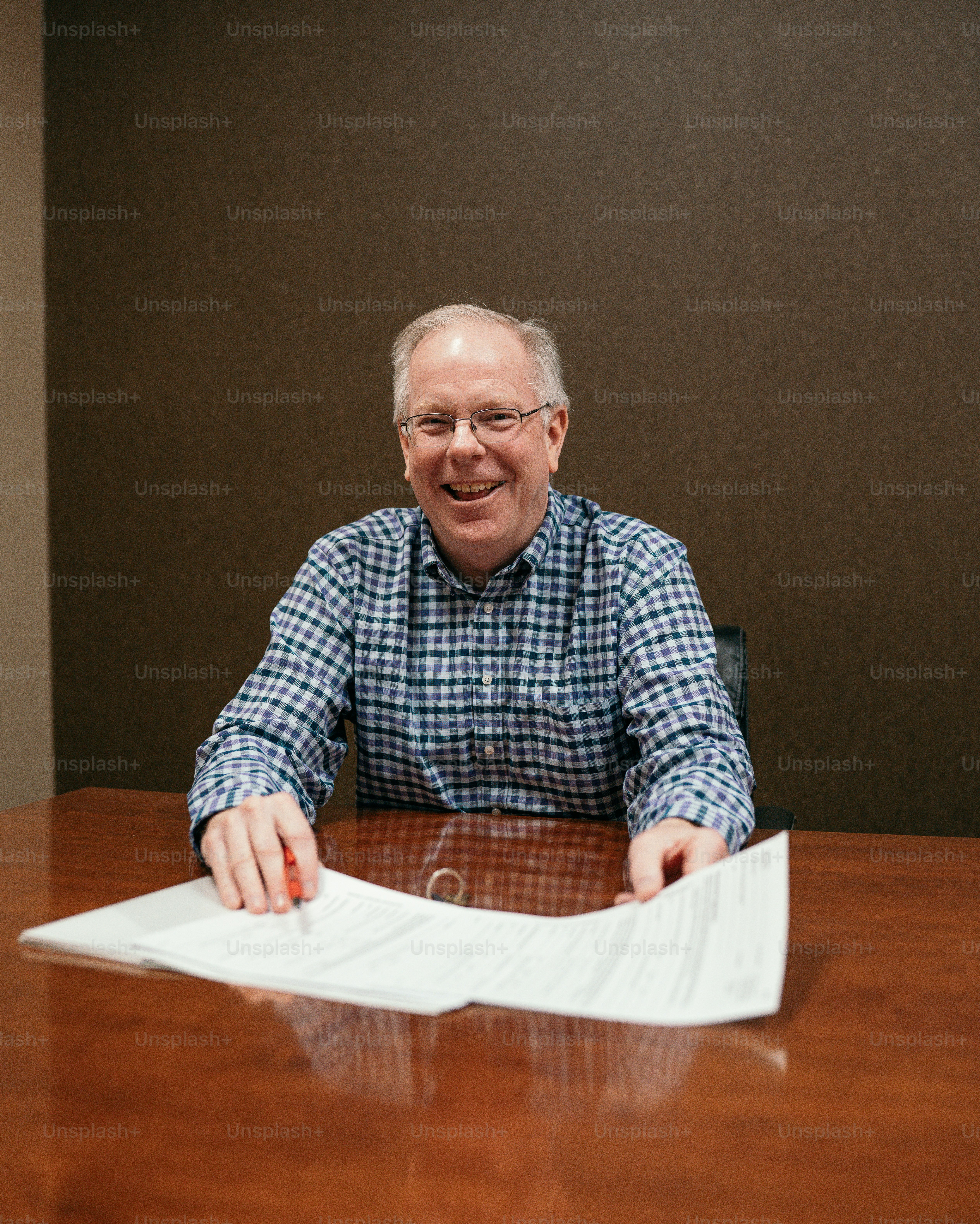 a man sitting at a table with a piece of paper in front of him