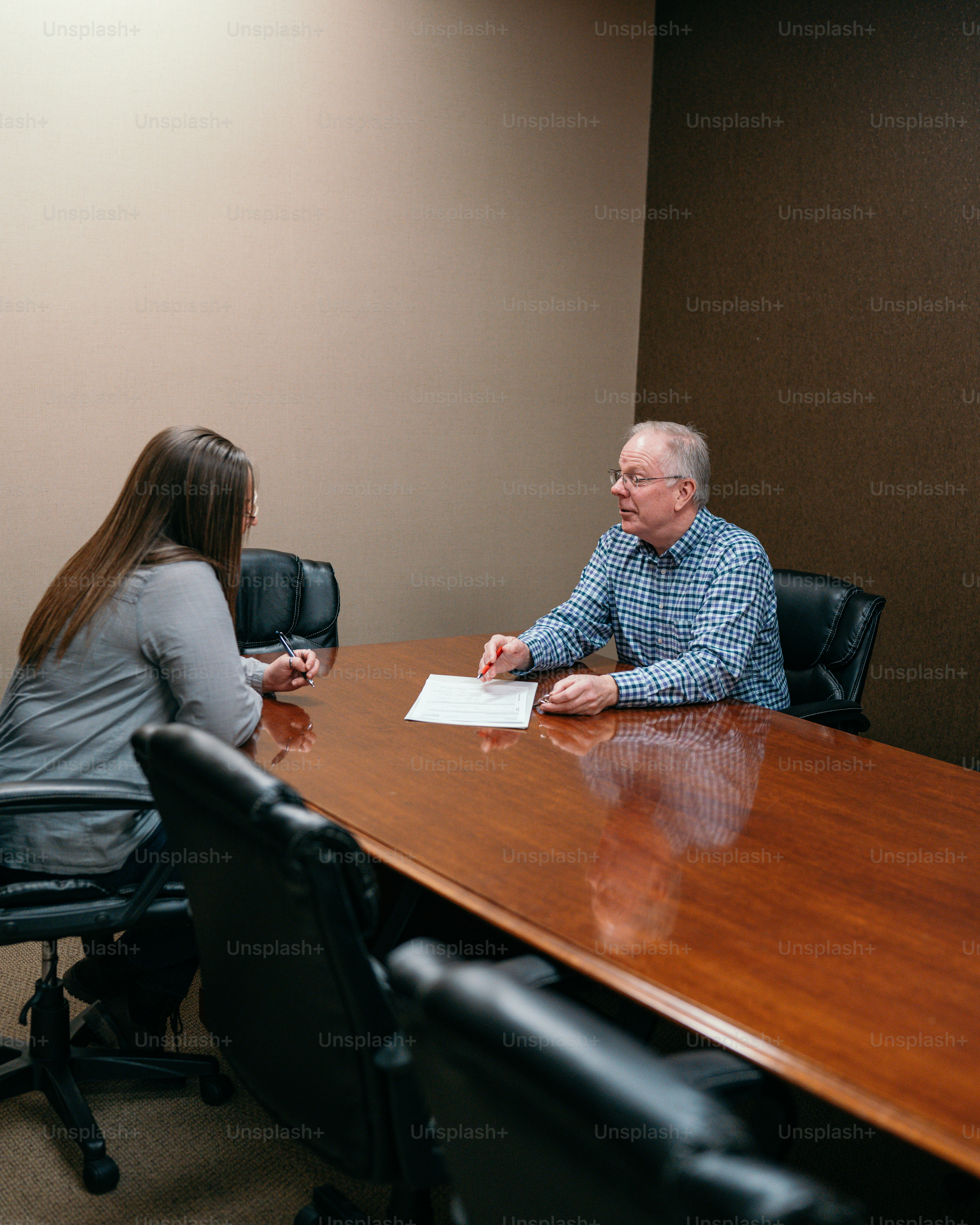 a man and a woman sitting at a conference table